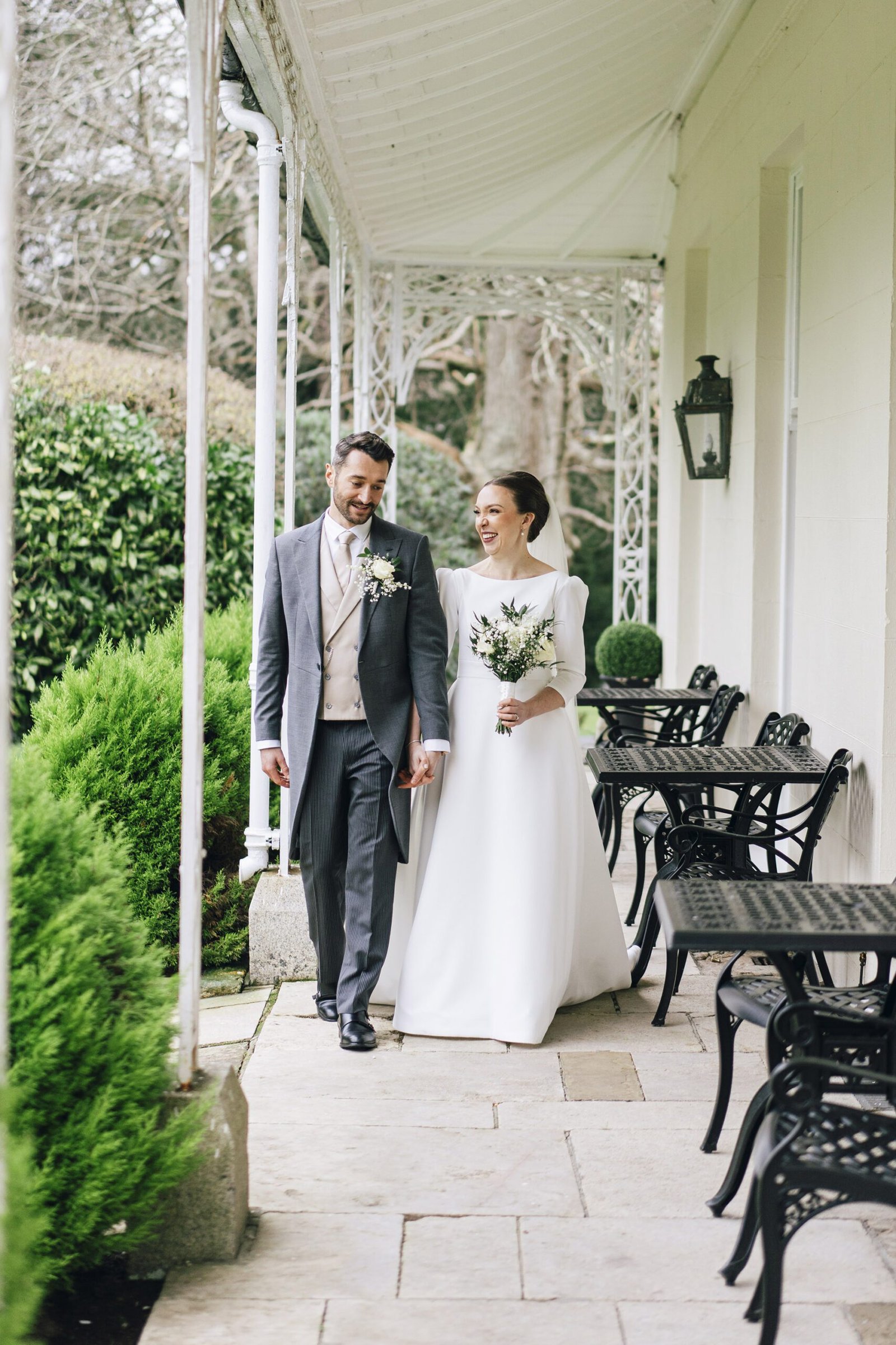 Golden hour wedding portraits of a happy couple in the lush gardens of St Elizabeth’s House, Plympton