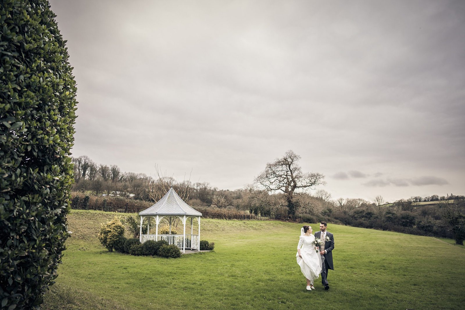 Golden hour wedding portraits of a happy couple in the lush gardens of St Elizabeth’s House, Plympton